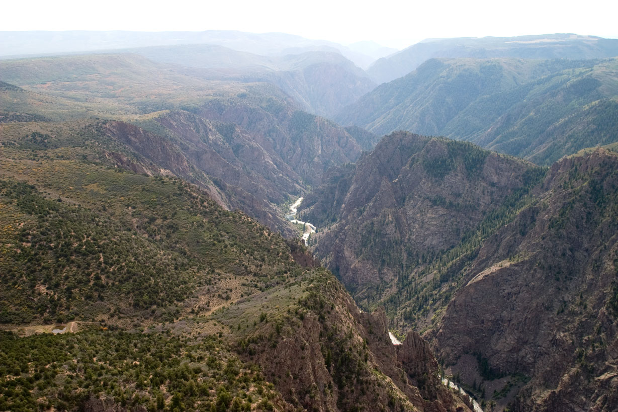 Steep dark cliffs of Black Canyon of the Gunnison plunging to the Gunnison River, Colorado