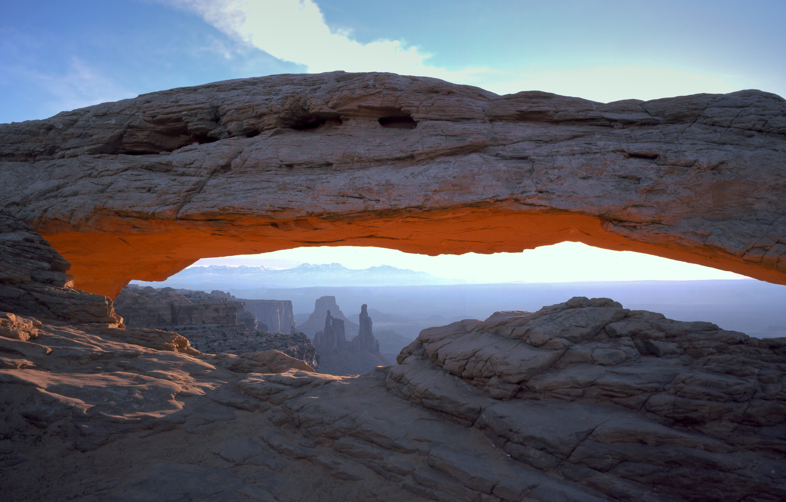 Sunrise light under Mesa Arch framing canyon country in Canyonlands National Park