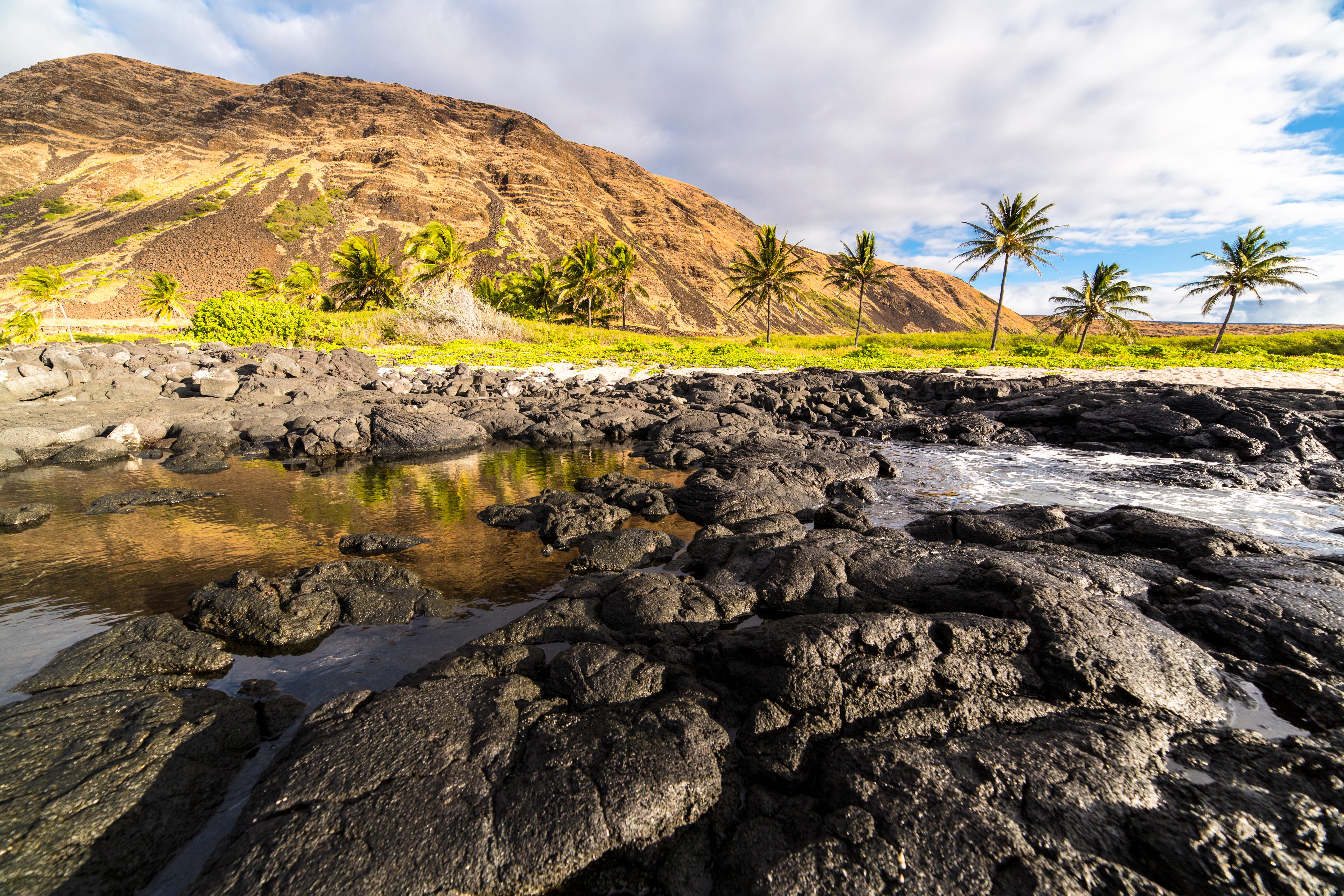 Hikers crossing the steaming, solidified lava floor of Kilauea Iki crater in Hawaii Volcanoes National Park