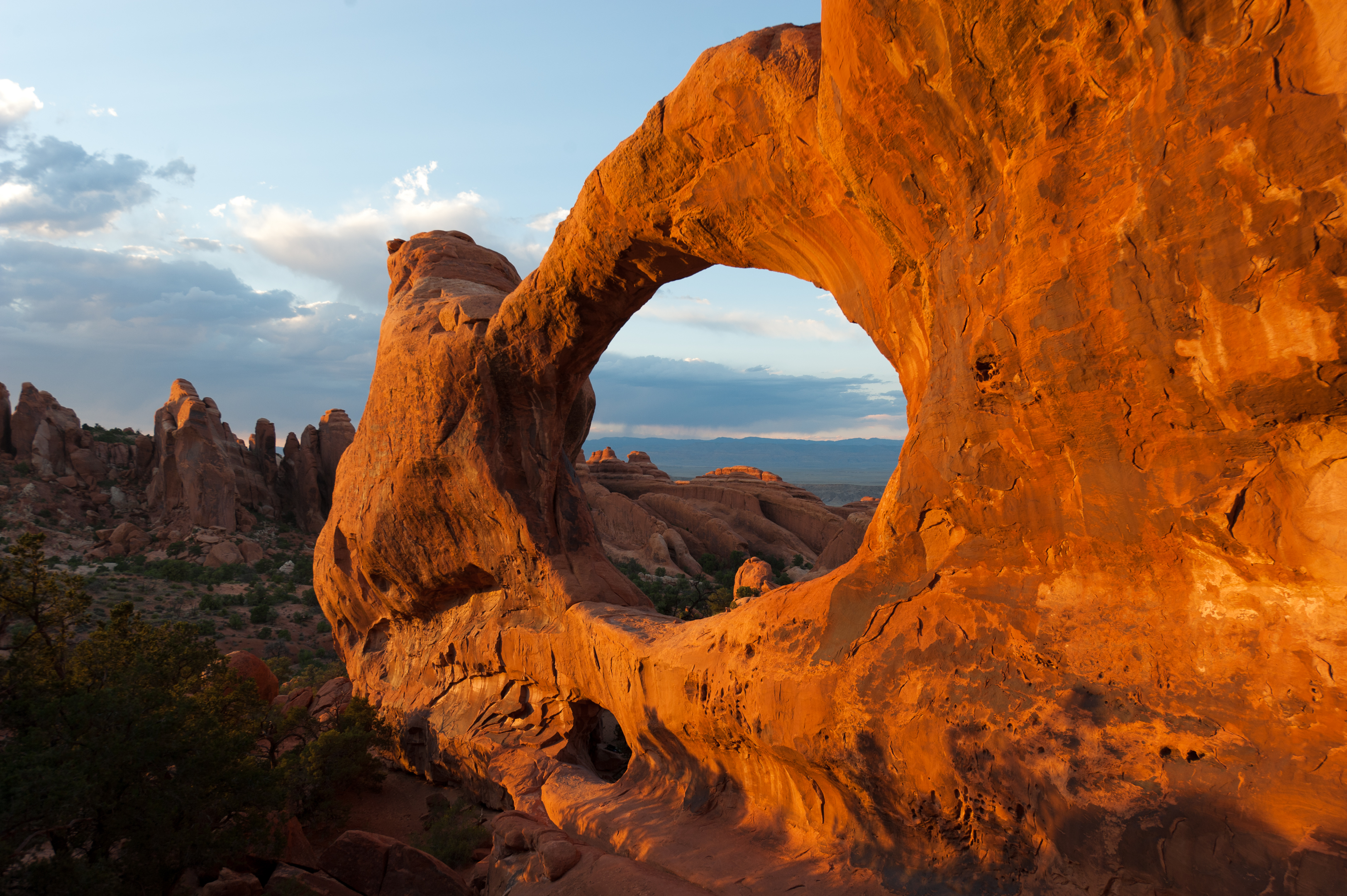 Delicate Arch glowing orange at sunset in Arches National Park, Utah