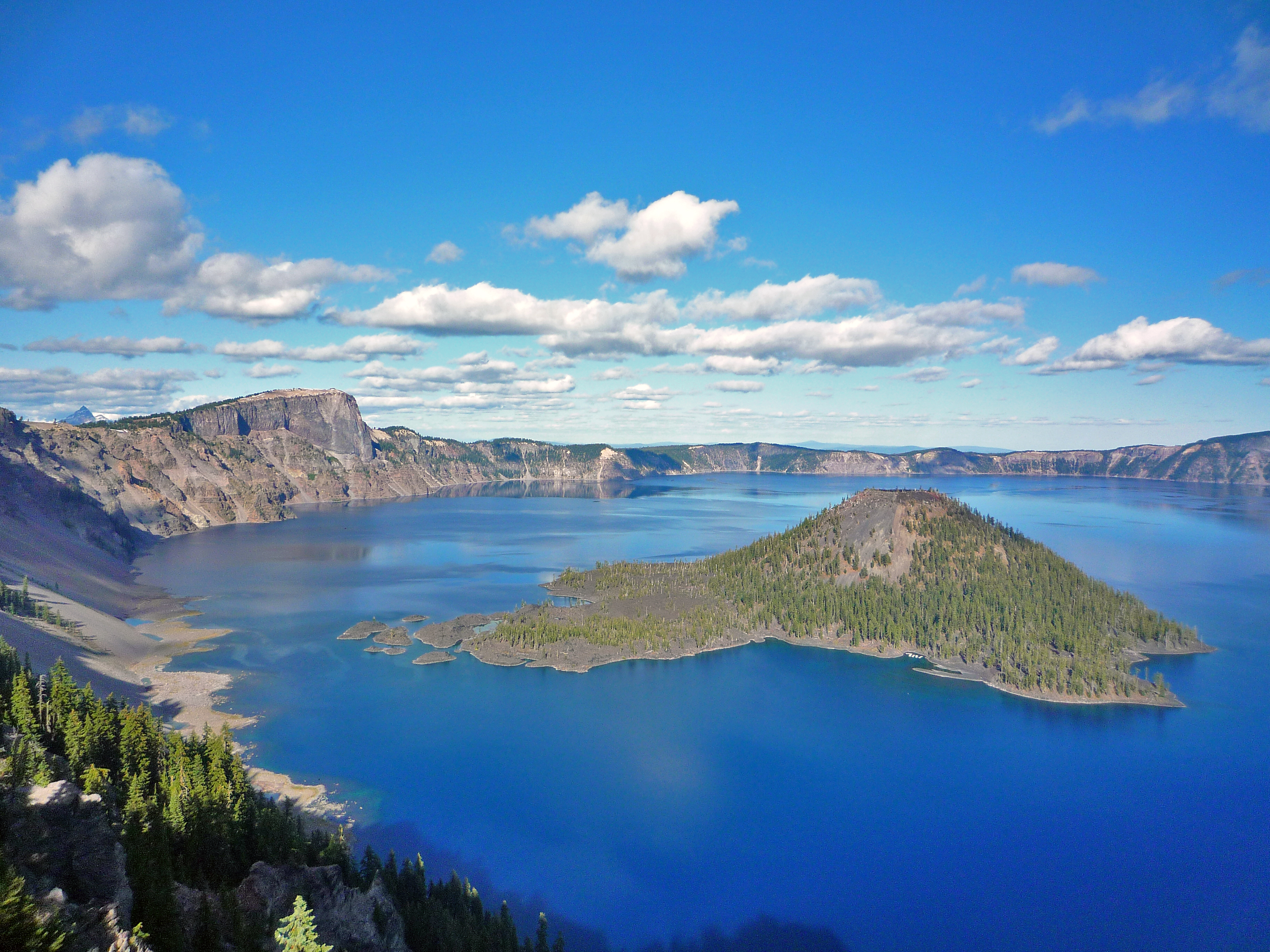 Deep blue Crater Lake with Wizard Island seen from the caldera rim in Crater Lake National Park, Oregon