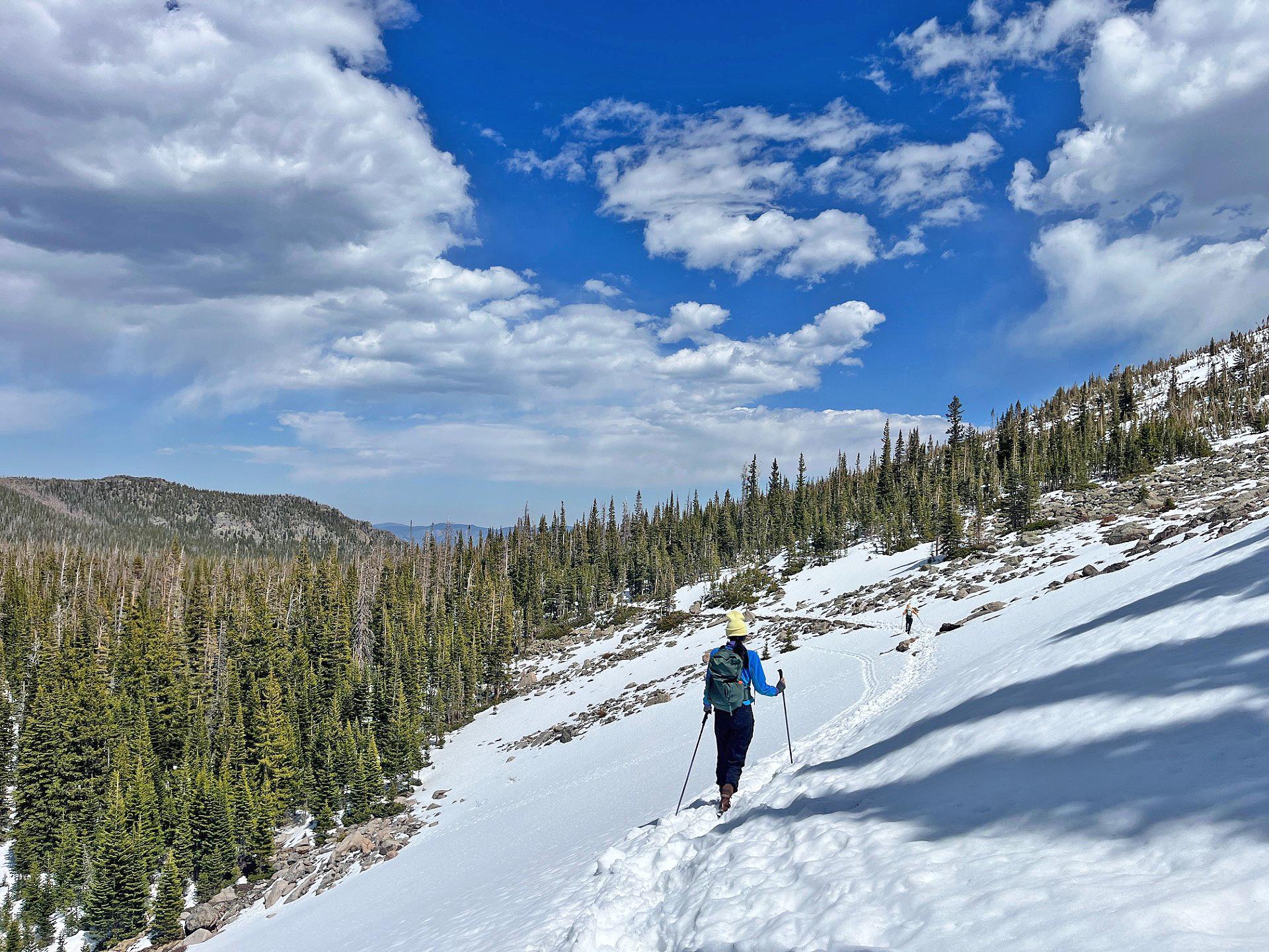 Hiker on a snowy alpine trail in Rocky Mountain National Park